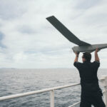 Sailor 1st Class Frank Moore of His Majesty's Canadian Ship MAX BERNAYS lauches PUMA Uncrewed Aircraft System during Operation NEON at sea on 22 September 2025. Photo Credit: Sailor 1st Class Jordan Schilstra, Canadian Armed Forces Photo