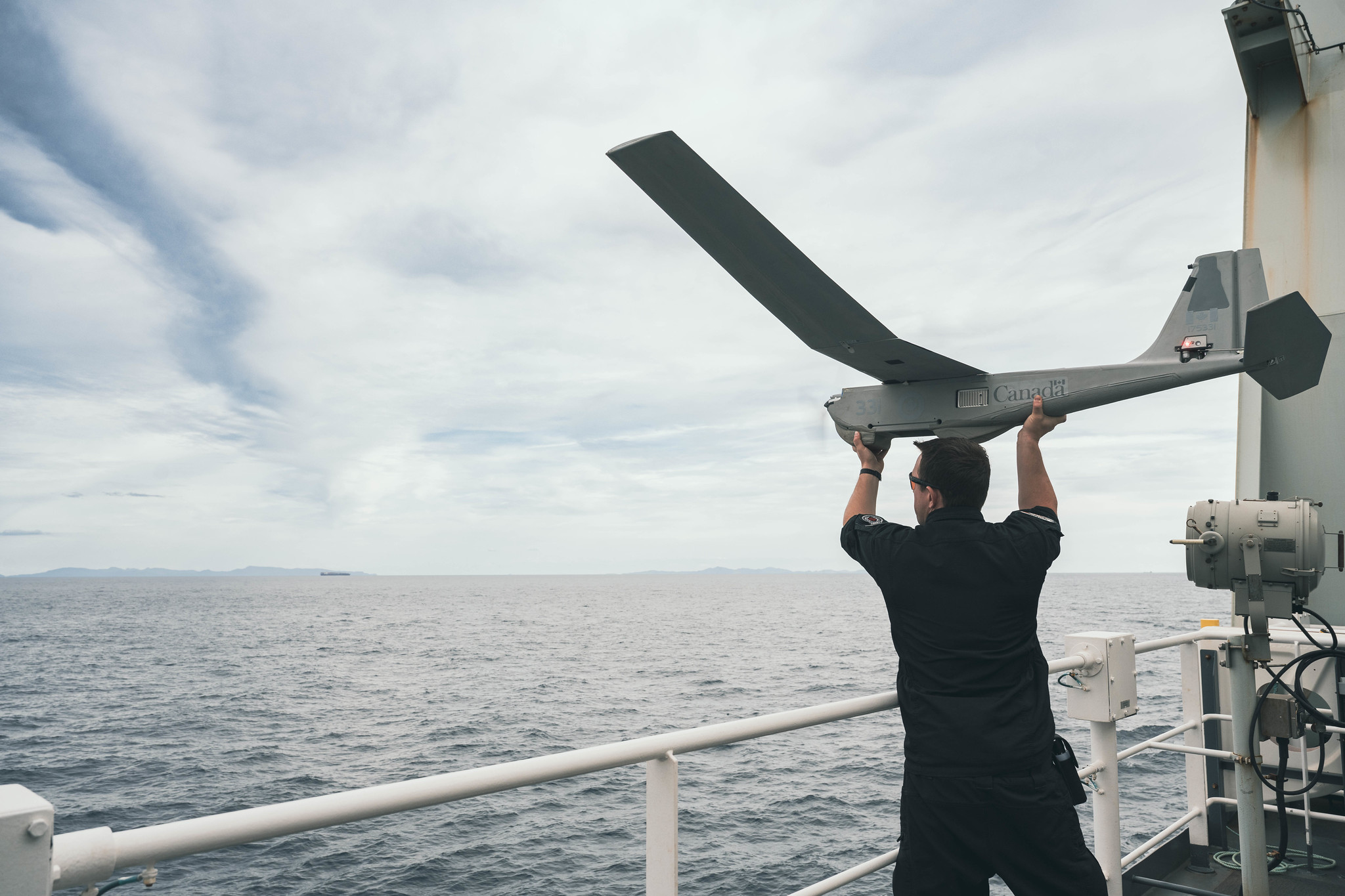 Sailor 1st Class Frank Moore of His Majesty's Canadian Ship MAX BERNAYS lauches PUMA Uncrewed Aircraft System during Operation NEON at sea on 22 September 2025. Photo Credit: Sailor 1st Class Jordan Schilstra, Canadian Armed Forces Photo