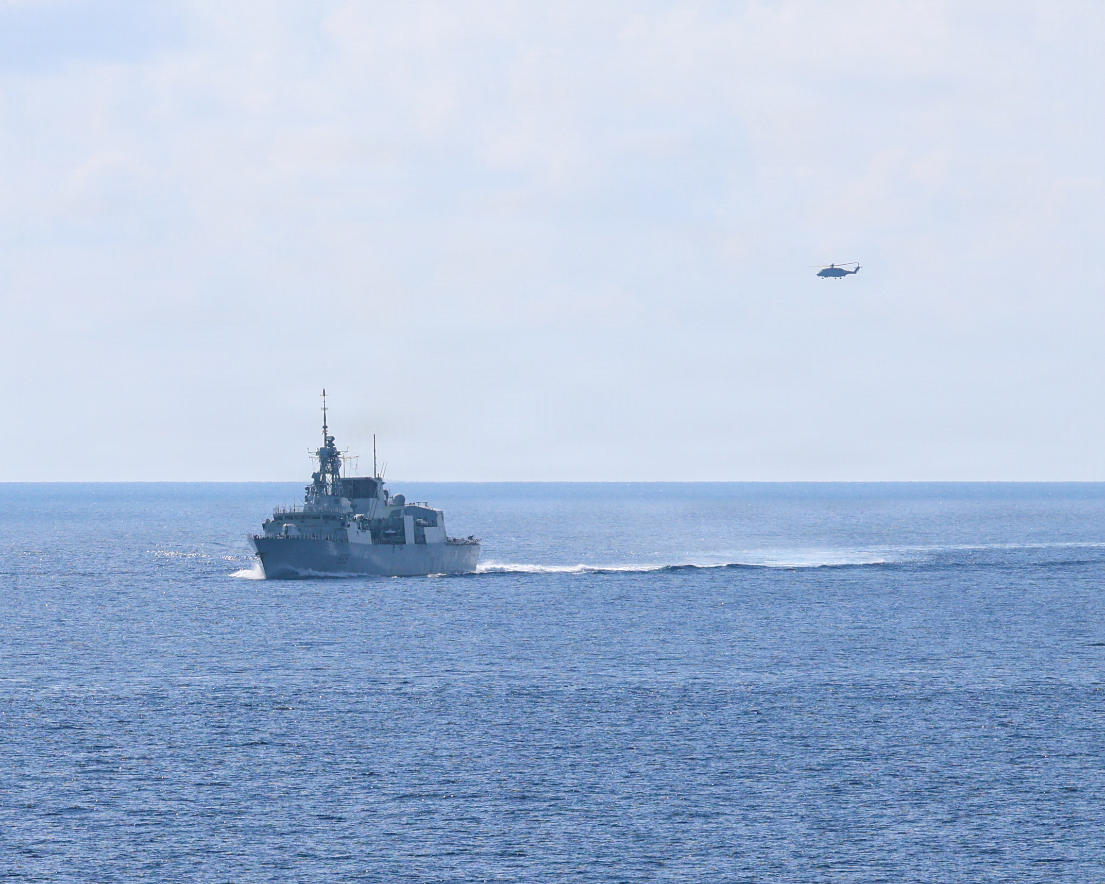 Royal Canadian Navy Halifax-class frigate HMCS Charlottetown (FFH 339) maneuvers into formation with Whidbey Island-class dock landing ship USS Ashland (LSD 48) after taking on fuel from Canadian supply ship MV Asterix during a multilateral exercise with the Royal Australian Navy and Royal Canadian Armed Forces in the South China Sea, April 14, 2026. Ashland and embarked Sailors and Marines from Task Force Ashland are a flexible crisis response force, purpose-built to integrate with allies and partners in support of a free and open Indo-Pacific. This forward deployment demonstrates the unwavering U.S. commitment to regional security and stability. U.S. 7th Fleet, the U.S. Navy’s largest forward-deployed numbered fleet, routinely interacts and operates with allies and partners in preserving a free and open Indo-Pacific. (U.S. Navy photo by Mass Communication Specialist 1st Class John B. Hetherington)