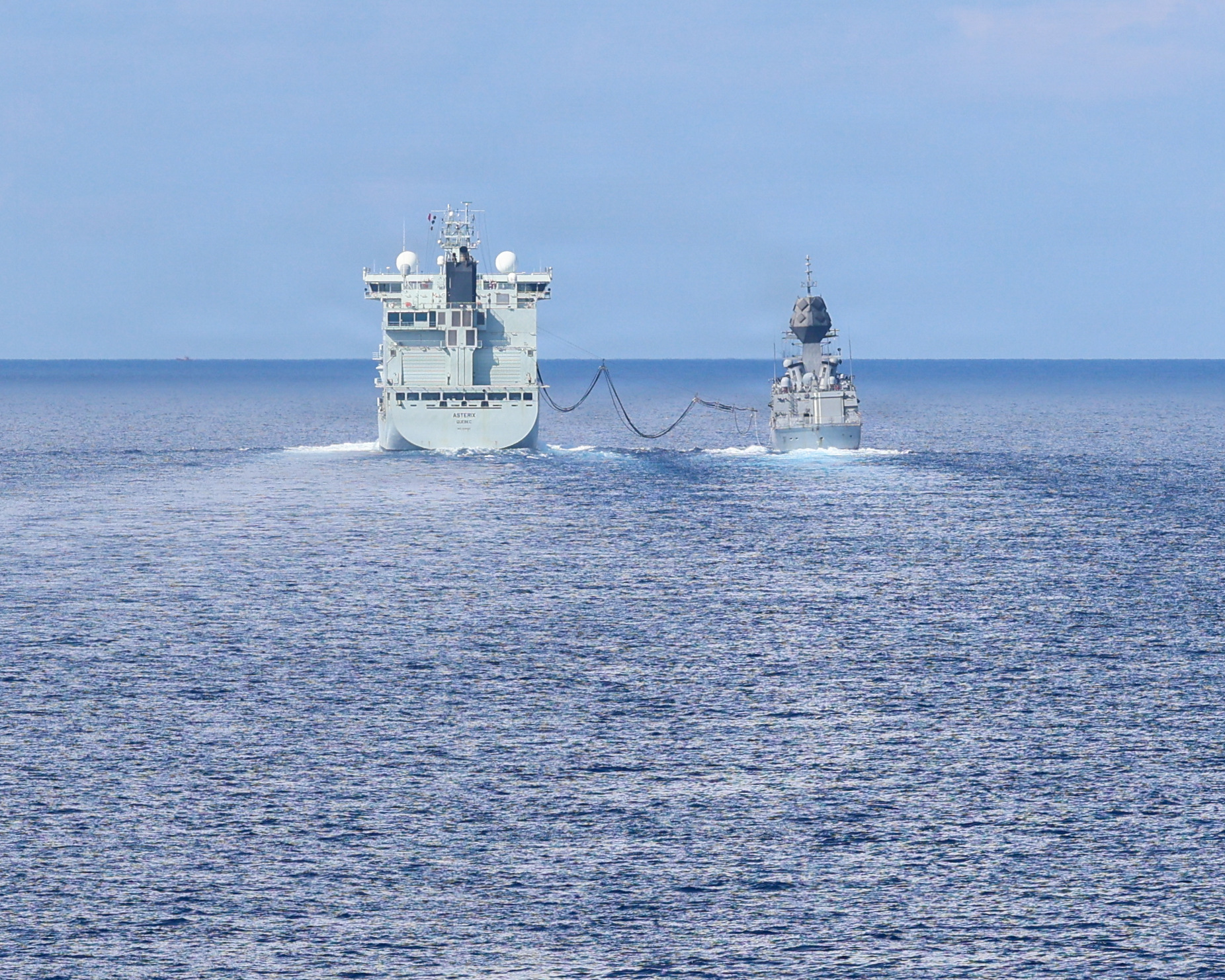 Canadian supply ship MV Asterix extends its fuel boom to Royal Australian Navy (RAN) Anzac-class frigate HMAS Toowoomba (FFH 156) in the South China Sea, April 14, 2026. (U.S. Navy photo by Mass Communication Specialist 1st Class John B. Hetherington)