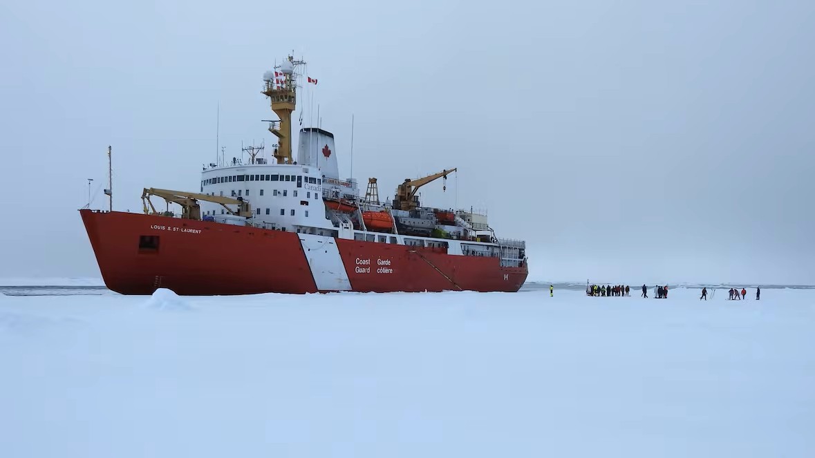 Crew members of the CCGS Louis S. St-Laurent gathered on the Arctic sea ice. (Submitted by the Canadian Coast Guard)