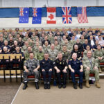Tactical development leaders, defense scientists, and military representatives from Australia, Canada, New Zealand, the United Kingdom, and the United States pose for an official group photo during the 2026 Maritime Warfare Working Group in Halifax, Canada, Sept. 21 to Sept. 25, 2026. Hosted by Canada this year, the annual event serves as a foundational forum under the Five Eyes Navy Talks charter to advance naval interoperability across surface, undersea, and mine warfare domains.