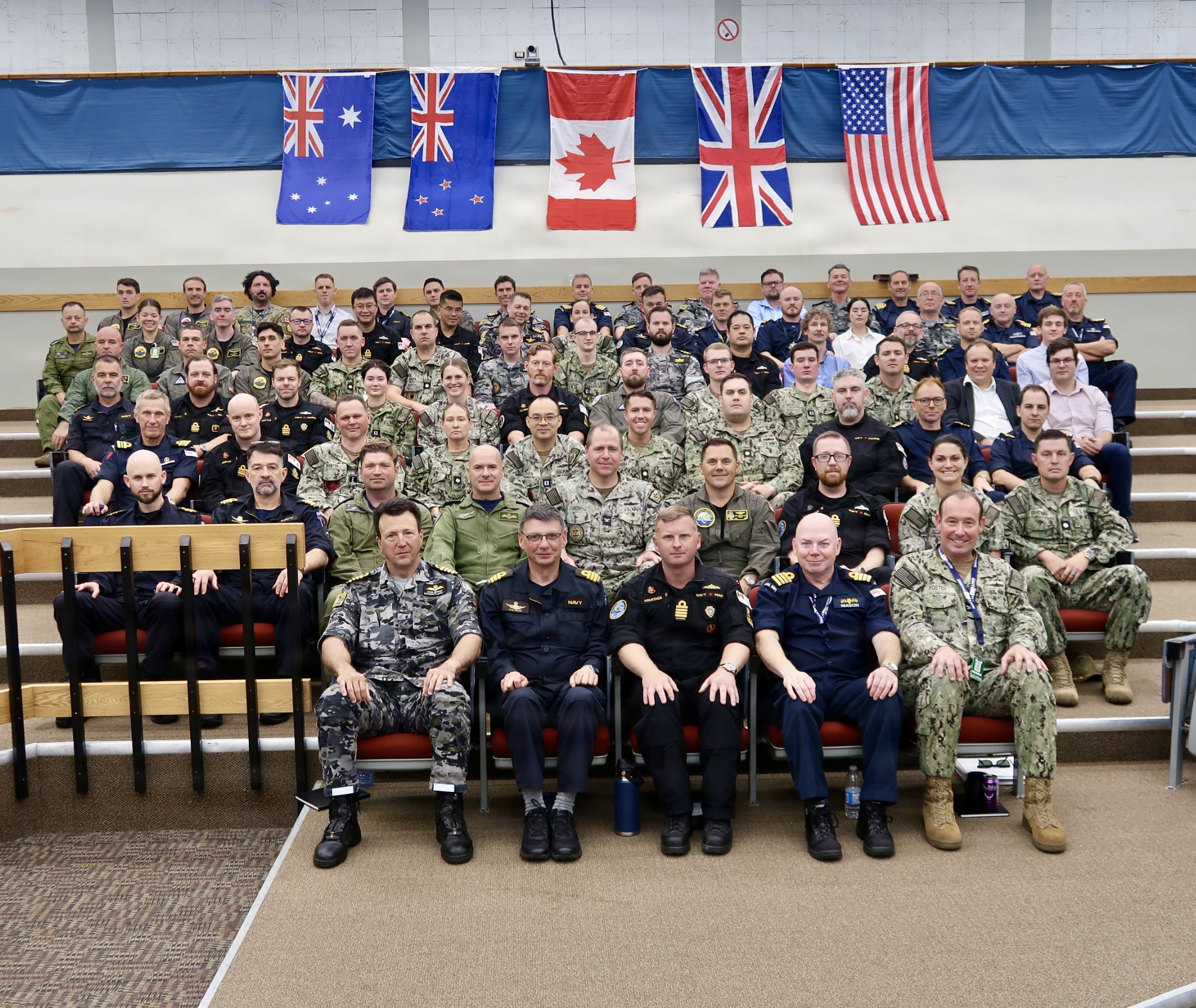 Tactical development leaders, defense scientists, and military representatives from Australia, Canada, New Zealand, the United Kingdom, and the United States pose for an official group photo during the 2026 Maritime Warfare Working Group in Halifax, Canada, Sept. 21 to Sept. 25, 2026. Hosted by Canada this year, the annual event serves as a foundational forum under the Five Eyes Navy Talks charter to advance naval interoperability across surface, undersea, and mine warfare domains.